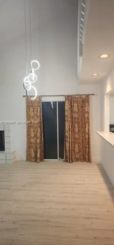 a view of an empty room with a chandelier