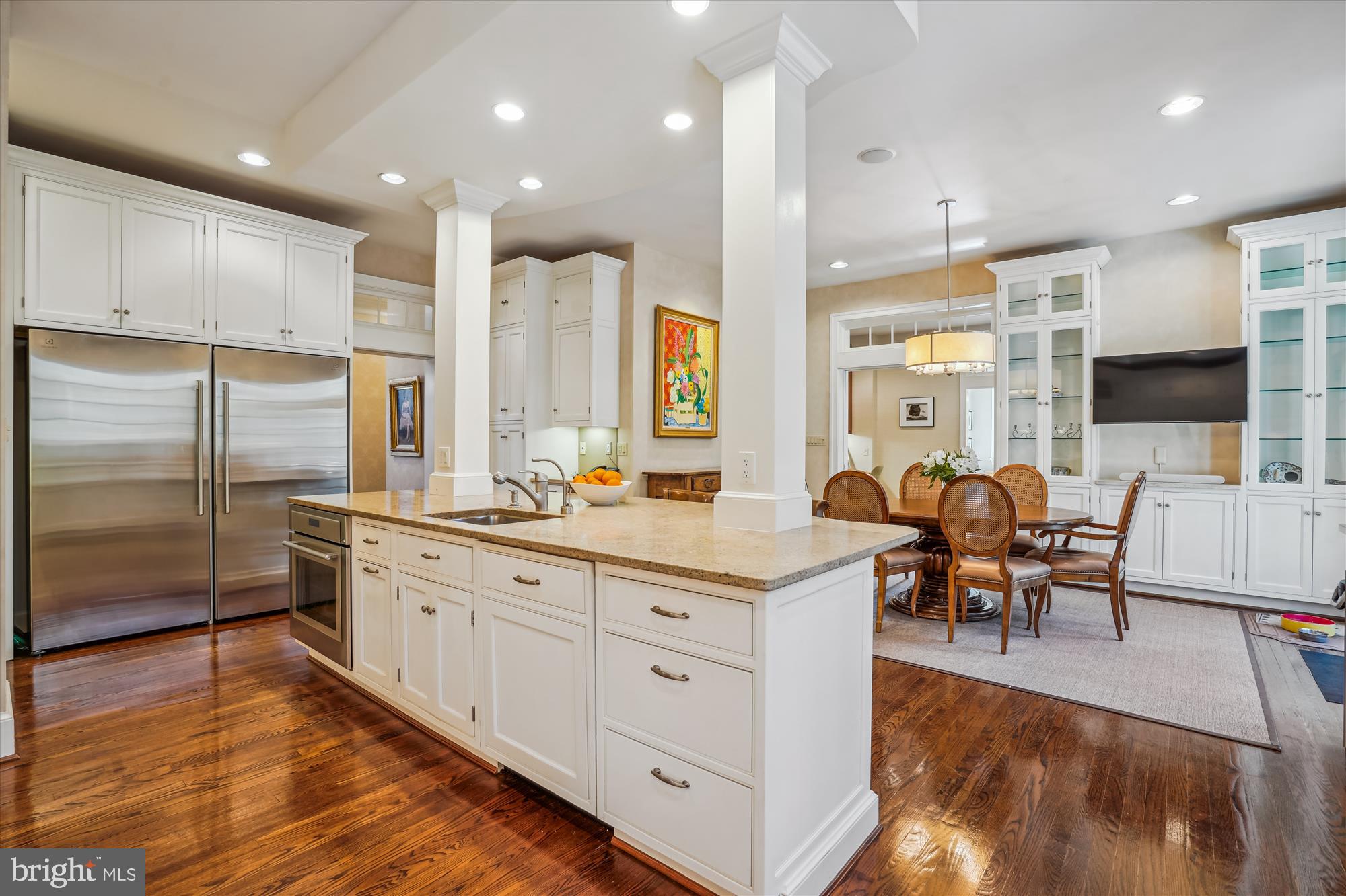 5008 Baltan Road Bethesda, MD 20816 - Photo 21 of 76 a large kitchen with kitchen island a large counter top space a sink stainless steel appliances and cabinets