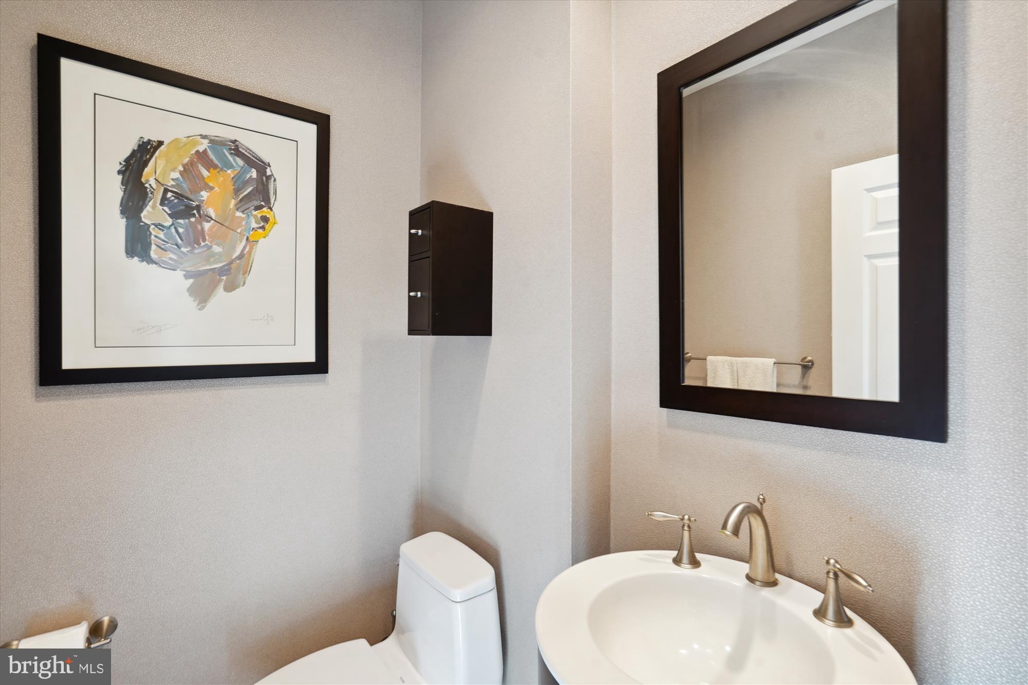5008 Baltan Road Bethesda, MD 20816 - Photo 26 of 76 a bathroom with a toilet sink and mirror