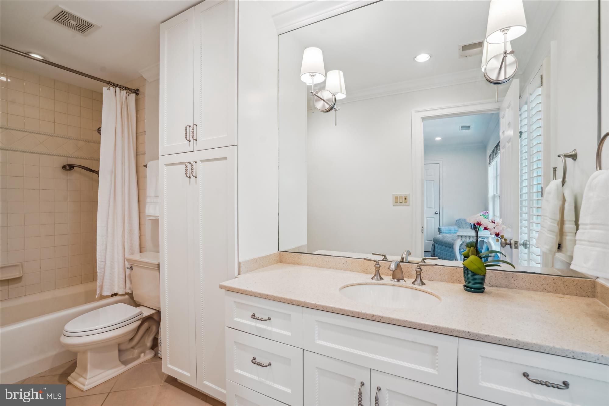 5008 Baltan Road Bethesda, MD 20816 - Photo 42 of 76 a bathroom with a granite countertop sink a toilet and a mirror