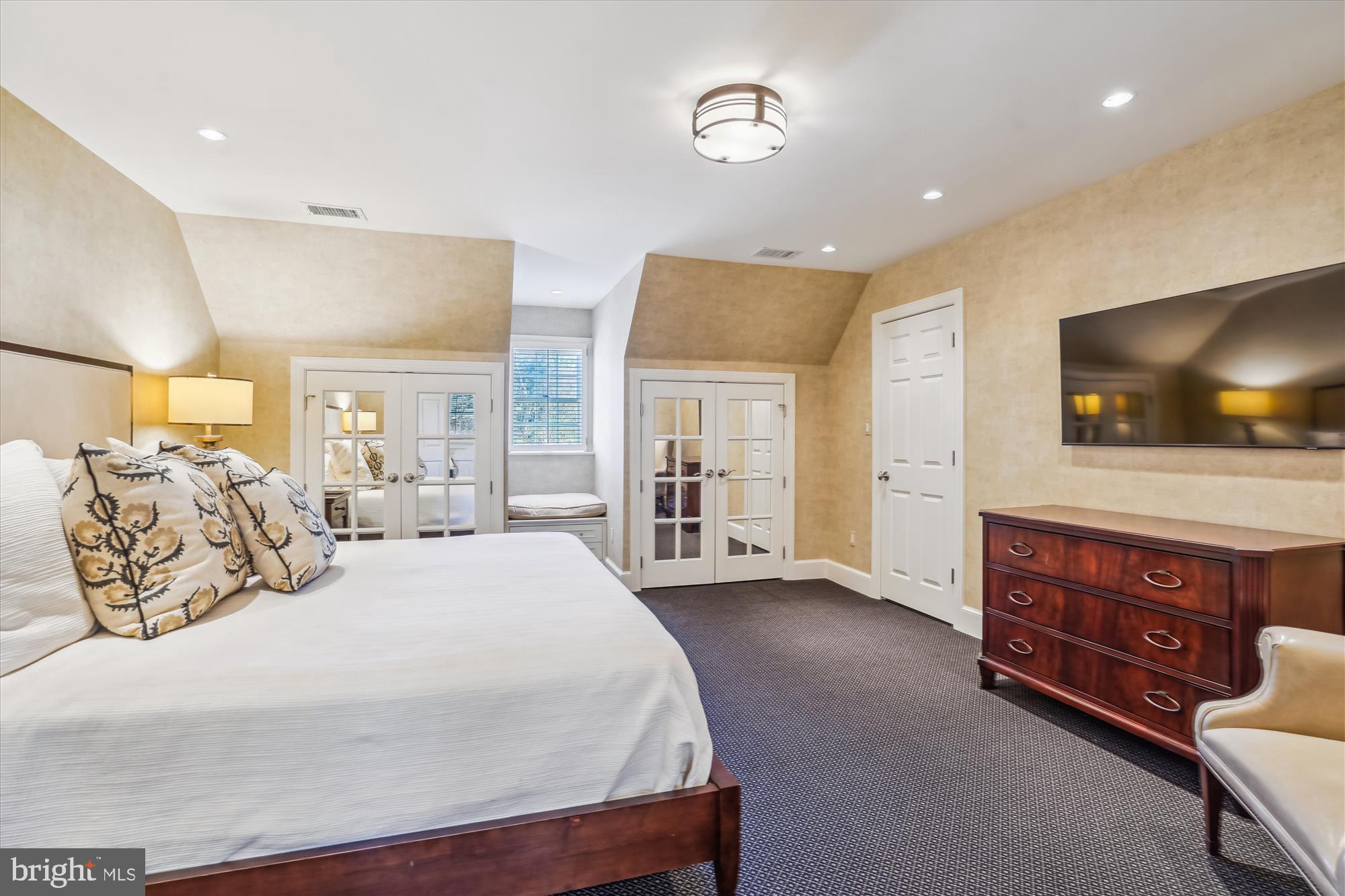 5008 Baltan Road Bethesda, MD 20816 - Photo 53 of 76 a spacious bedroom with a bed and a flat screen television