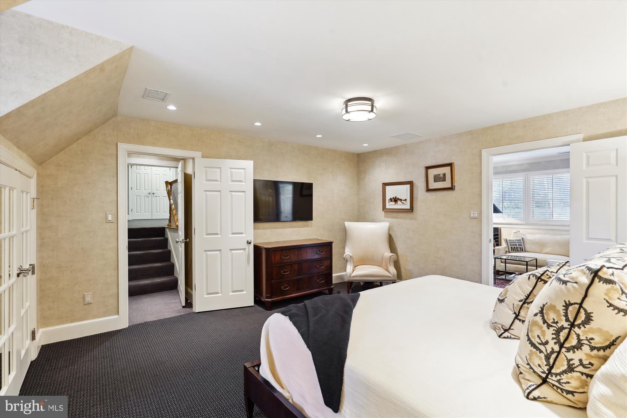 5008 Baltan Road Bethesda, MD 20816 - Photo 54 of 76 a spacious bedroom with a bed and a flat screen tv