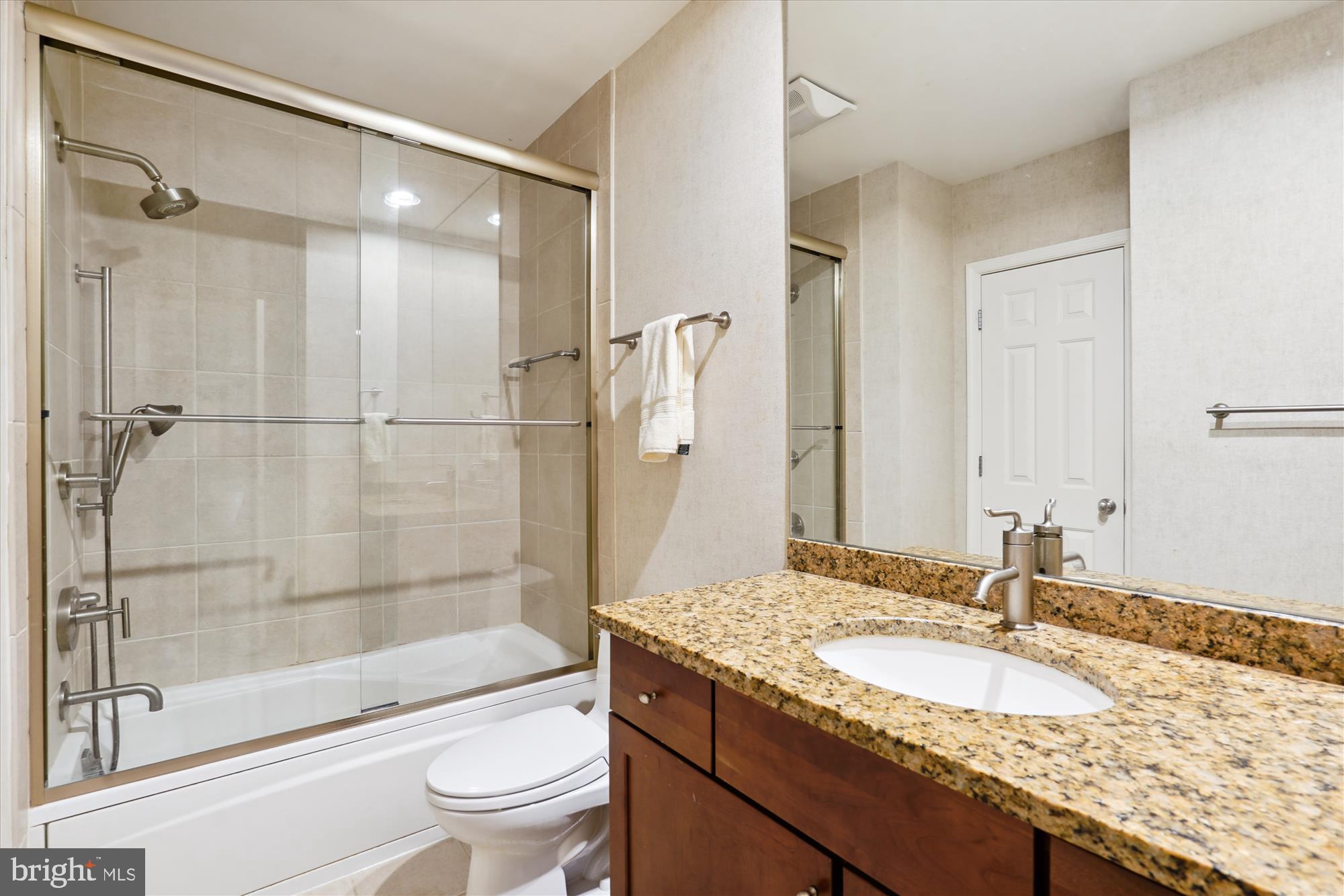 5008 Baltan Road Bethesda, MD 20816 - Photo 63 of 76 a bathroom with a granite countertop sink toilet and shower