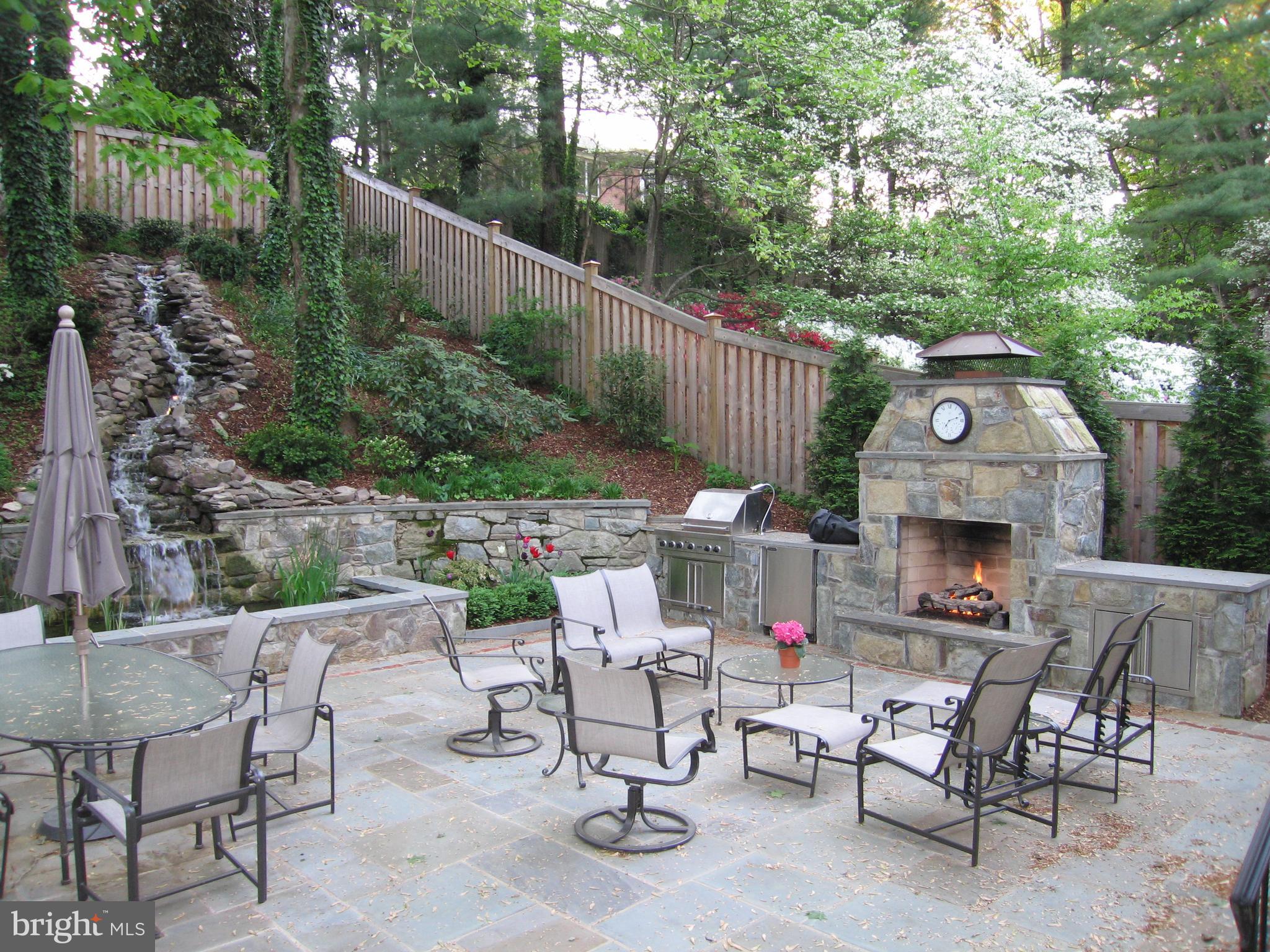 5008 Baltan Road Bethesda, MD 20816 - Photo 72 of 76 a view of a patio with a dining table and chairs with wooden fence
