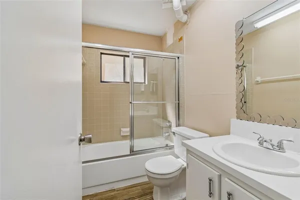 a view of a yard with plants and trees