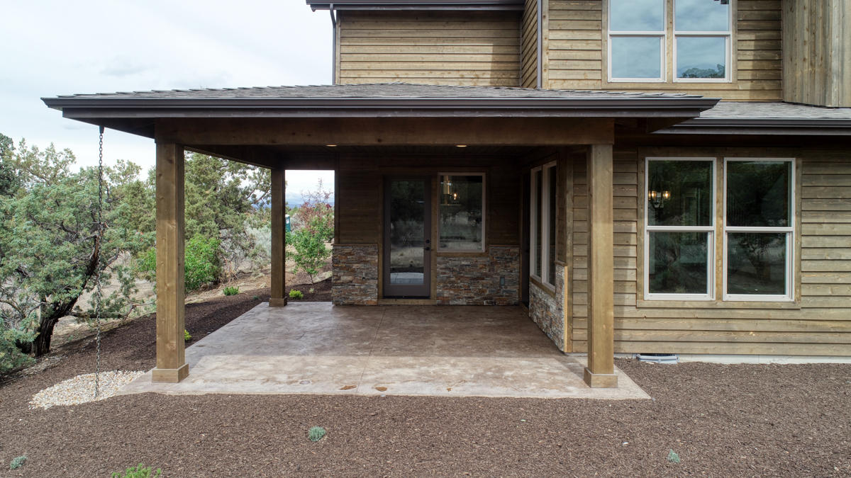 15751 South W Brasada Ranch Road, Unit LOT 363 Powell Butte, OR 97753 - Photo 11 of 47 a view of a porch with a table and chairs under an umbrella