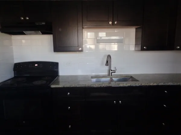 a kitchen with a sink and cabinets
