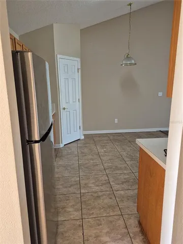 a kitchen with granite countertop a refrigerator stove top oven and sink