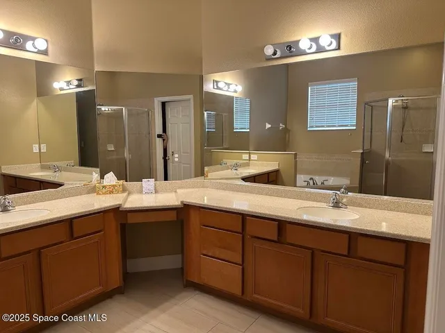 a bathroom with a granite countertop sink double and mirror