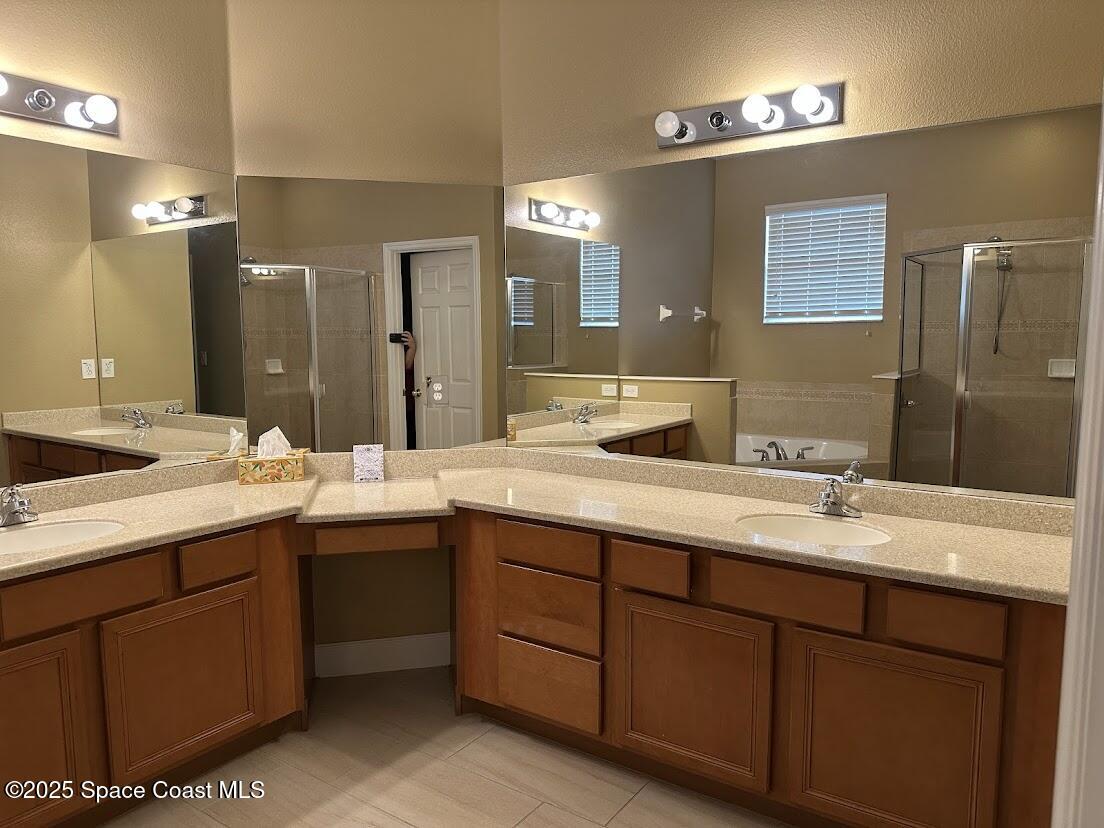 189 Wading Bird Circle Southwest Palm Bay, FL 32908 - Photo 12 of 23 a bathroom with a granite countertop sink double and mirror