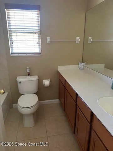 a bathroom with a sink toilet and a mirror