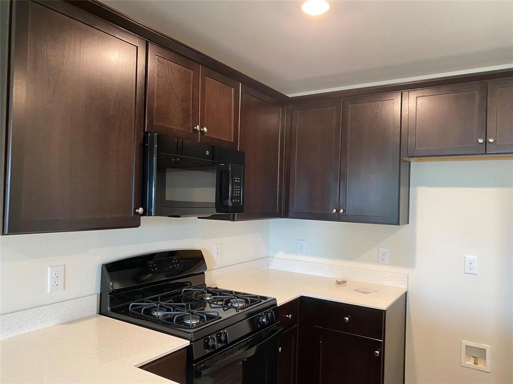 4408 Culrin Way Forney, TX 75126 - Photo 11 of 17 a kitchen with granite countertop stainless steel appliances and cabinets