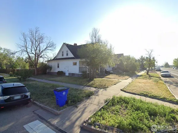 a view of a yard with cars