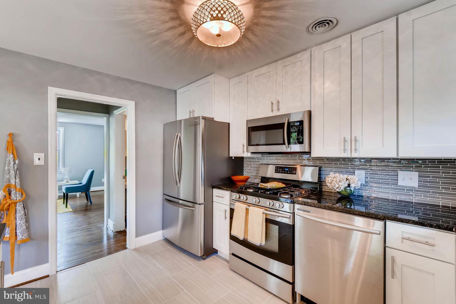 4823 Briarclift Road Baltimore, MD 21229 - Photo 12 of 30 a kitchen with stainless steel appliances granite countertop a refrigerator a stove and a sink