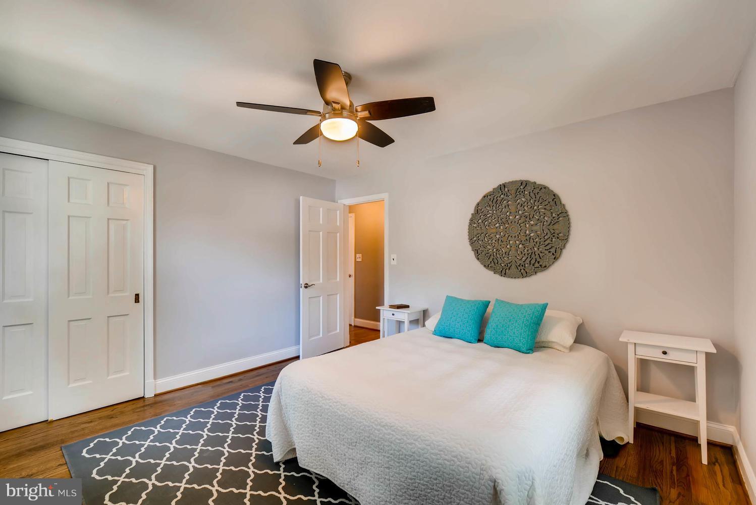 4823 Briarclift Road Baltimore, MD 21229 - Photo 15 of 30 a bedroom with a bed and wooden floor