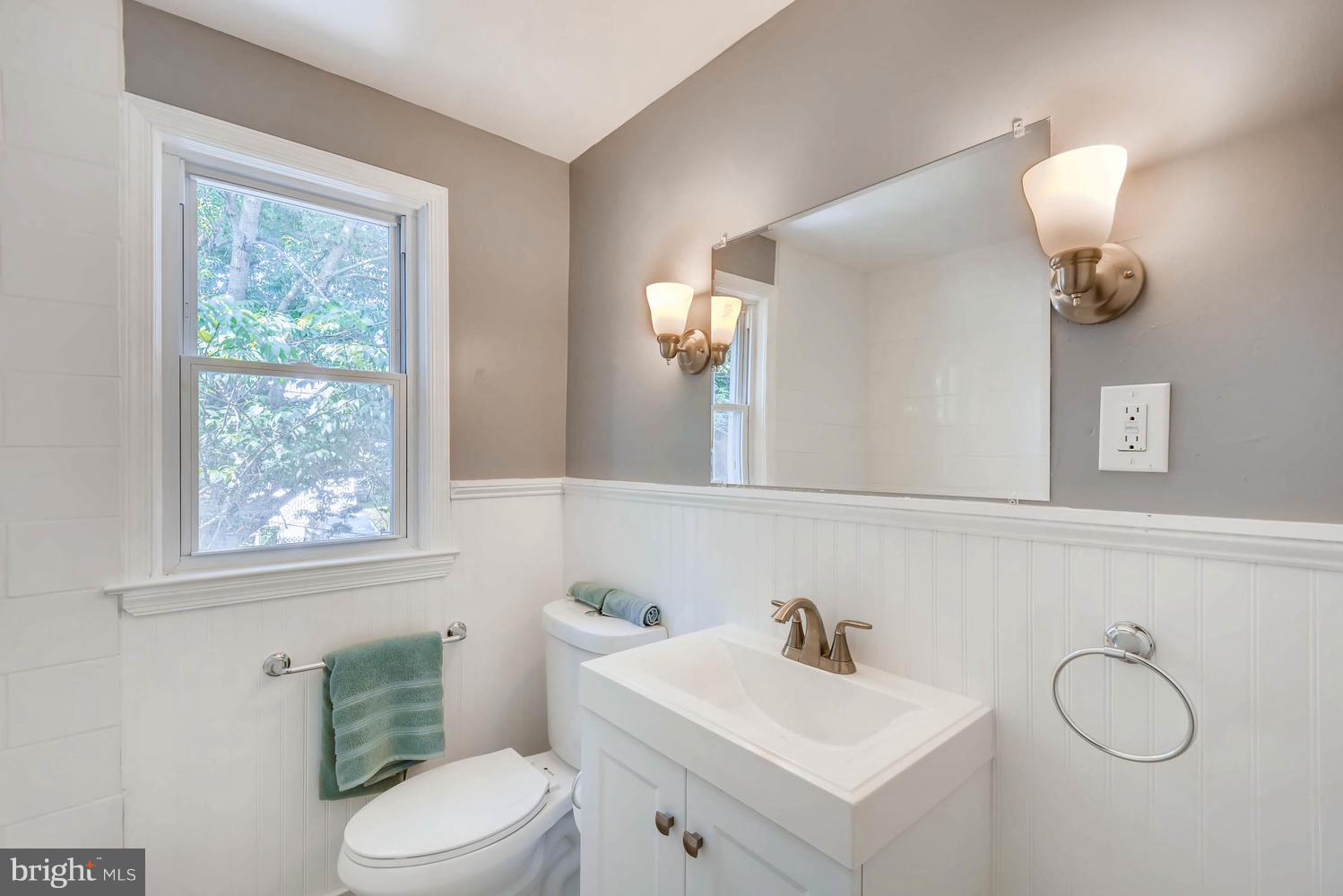 4823 Briarclift Road Baltimore, MD 21229 - Photo 16 of 30 a bathroom with a sink a toilet and a mirror