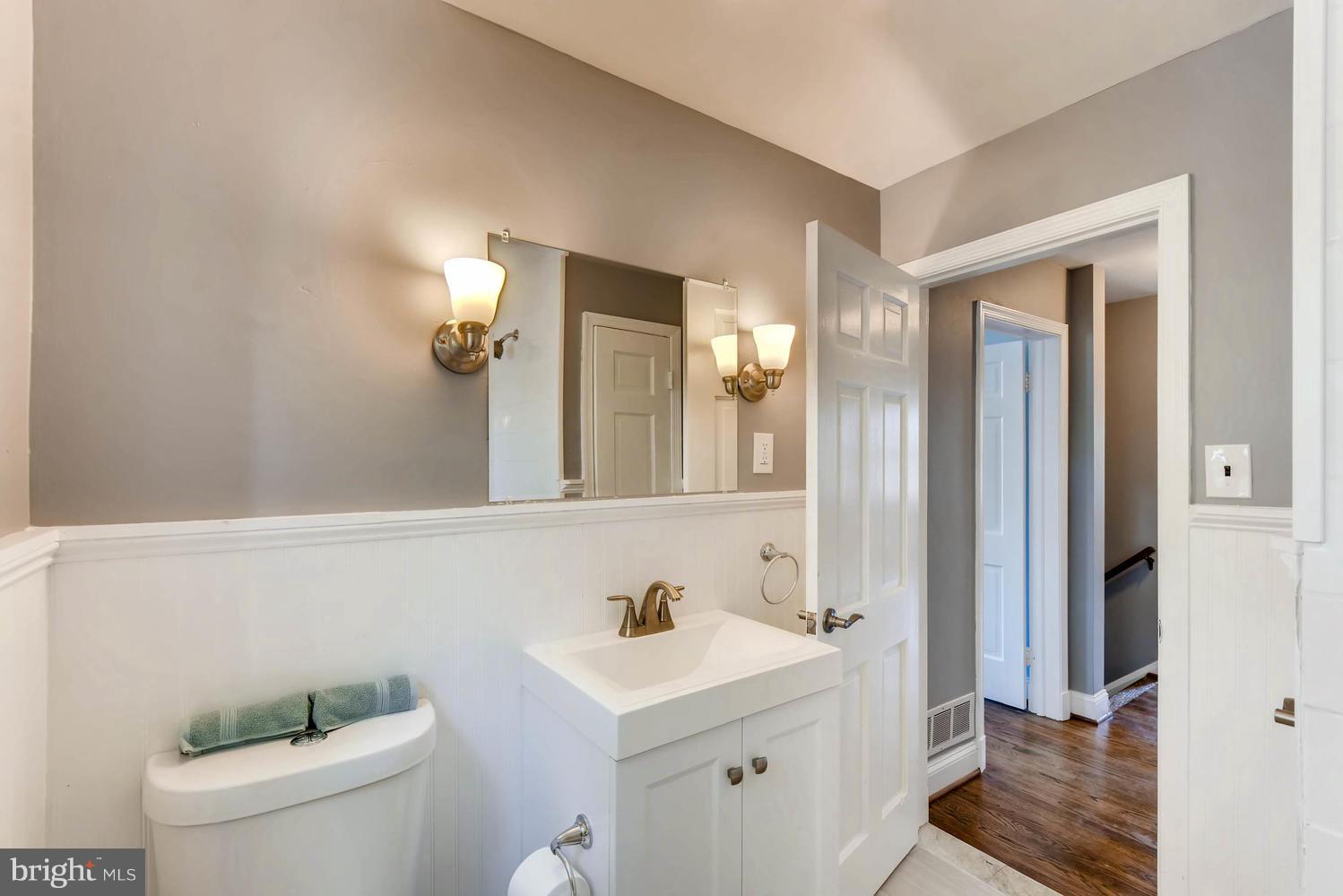 4823 Briarclift Road Baltimore, MD 21229 - Photo 18 of 30 a bathroom with a sink a toilet a mirror and shower