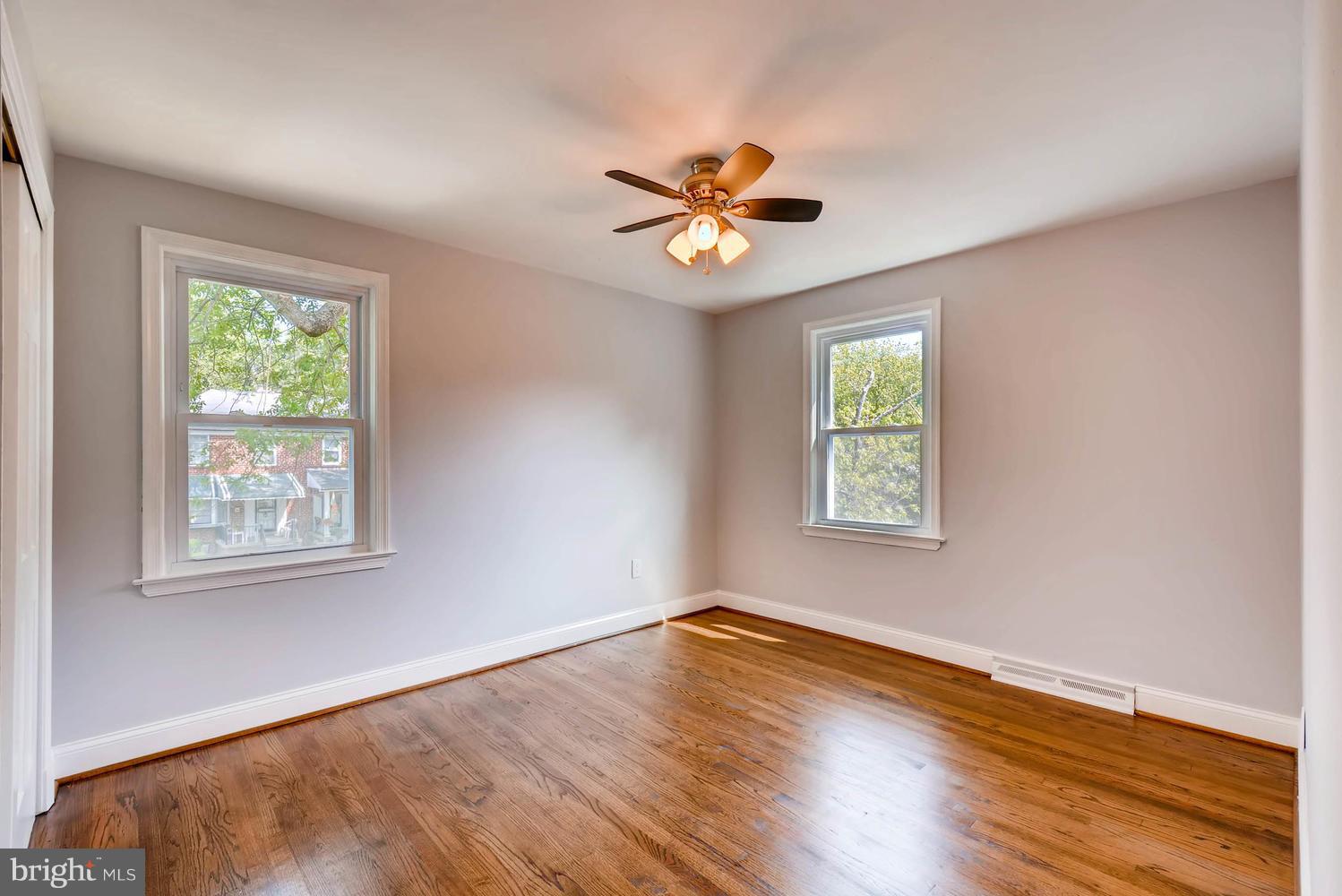 4823 Briarclift Road Baltimore, MD 21229 - Photo 21 of 30 a view of empty room with wooden floor and fan