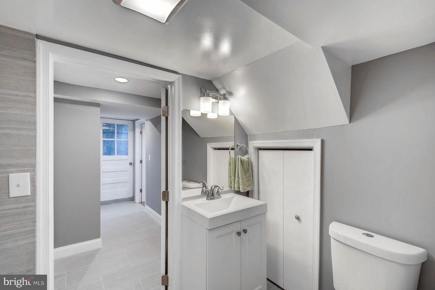 4823 Briarclift Road Baltimore, MD 21229 - Photo 29 of 30 a bathroom with a sink a toilet and a mirror