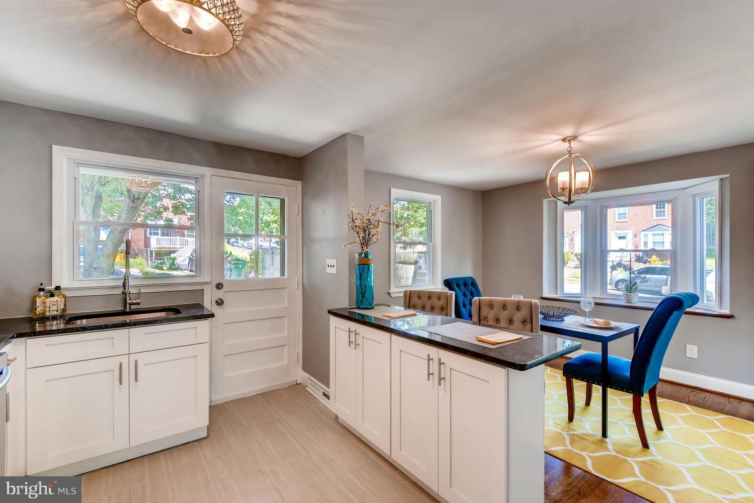 4823 Briarclift Road Baltimore, MD 21229 - Photo 10 of 30 a kitchen with granite countertop sink stove and dining table