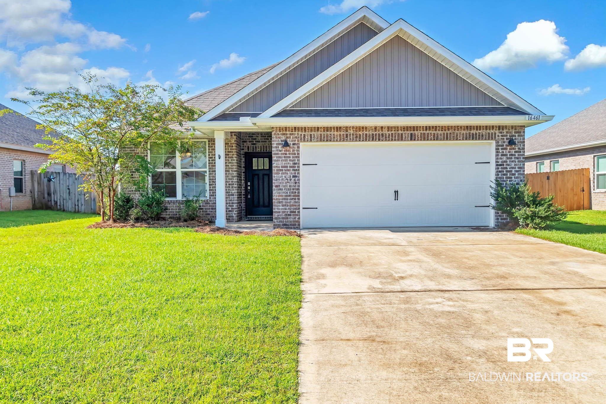 16461 Prado Loop Loxley, AL 36551 - Photo 1 of 78 View of front facade with brick siding, board and batten siding, a garage, and concrete driveway