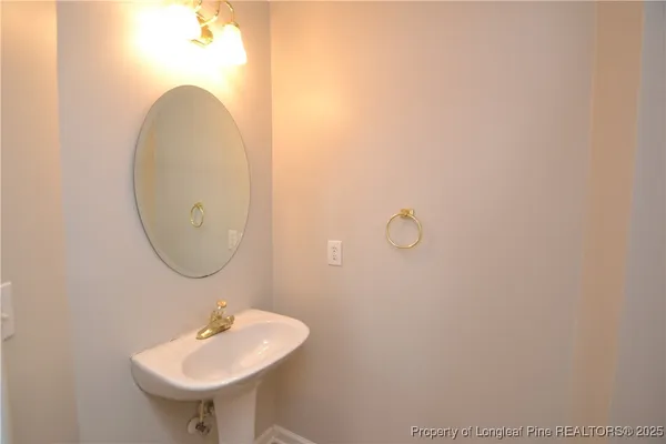 a kitchen with a sink a refrigerator and cabinets