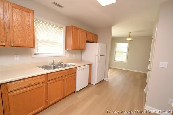 a kitchen with a white cabinets and white appliances