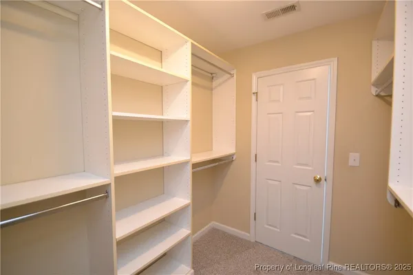 a white toilet sitting next to a white sink