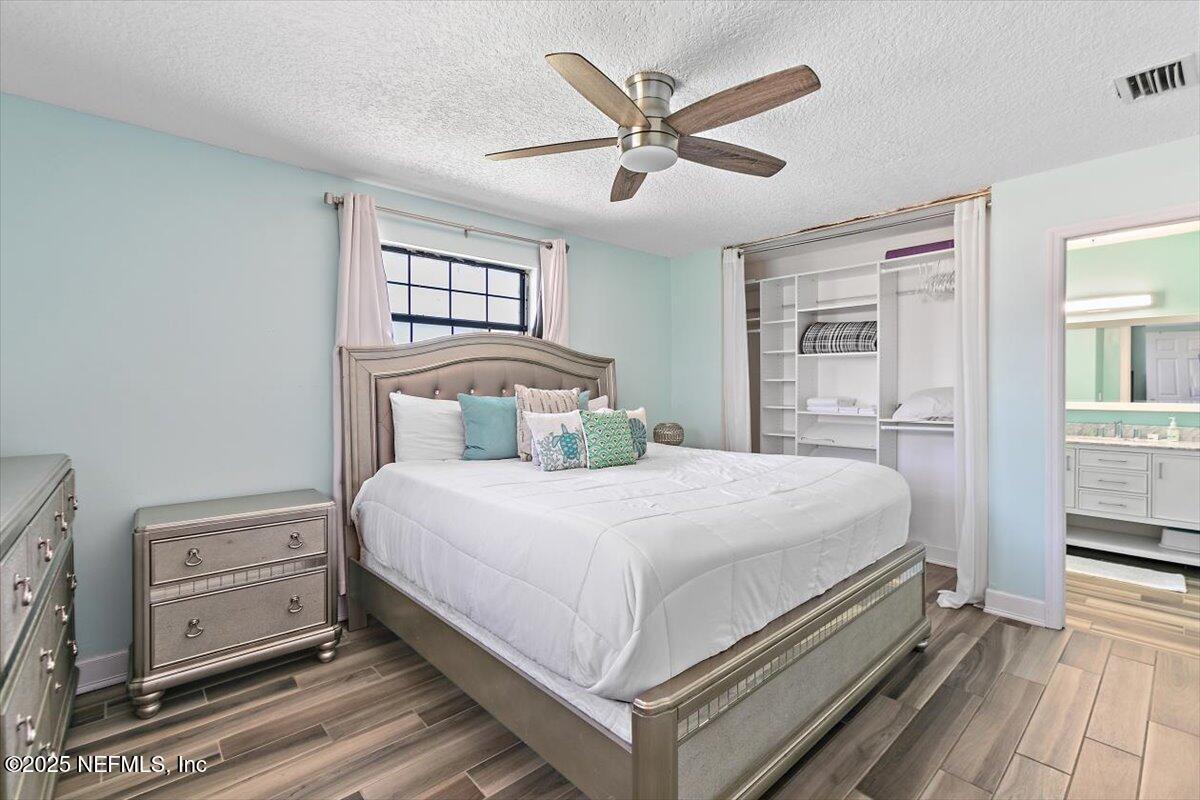 898 Perkins Place Jacksonville, FL 32221 - Photo 12 of 21 a bedroom with a large bed and a chandelier