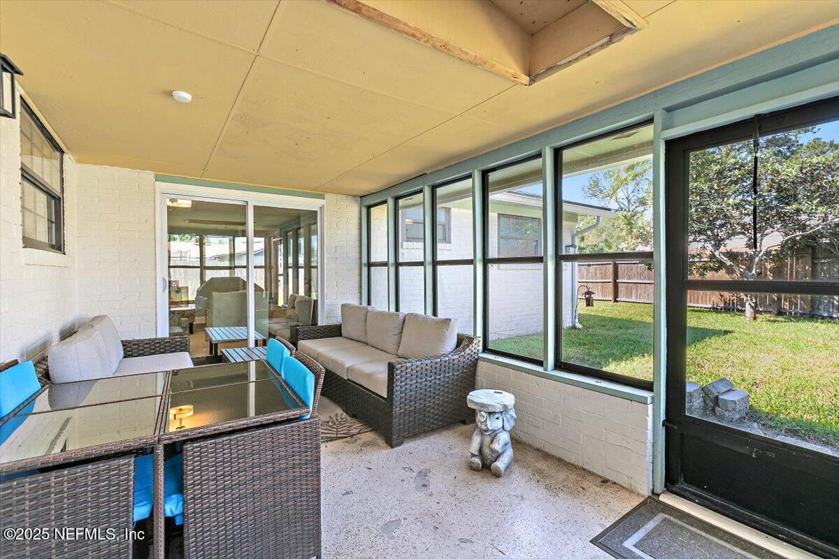 898 Perkins Place Jacksonville, FL 32221 - Photo 19 of 21 a living room with furniture and a floor to ceiling window