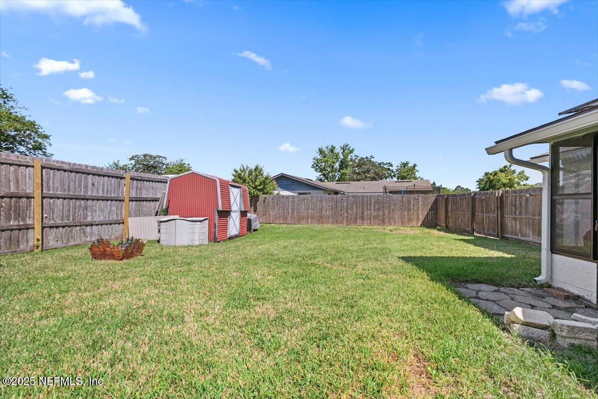 898 Perkins Place Jacksonville, FL 32221 - Photo 20 of 21 a backyard of a house with lots of green space