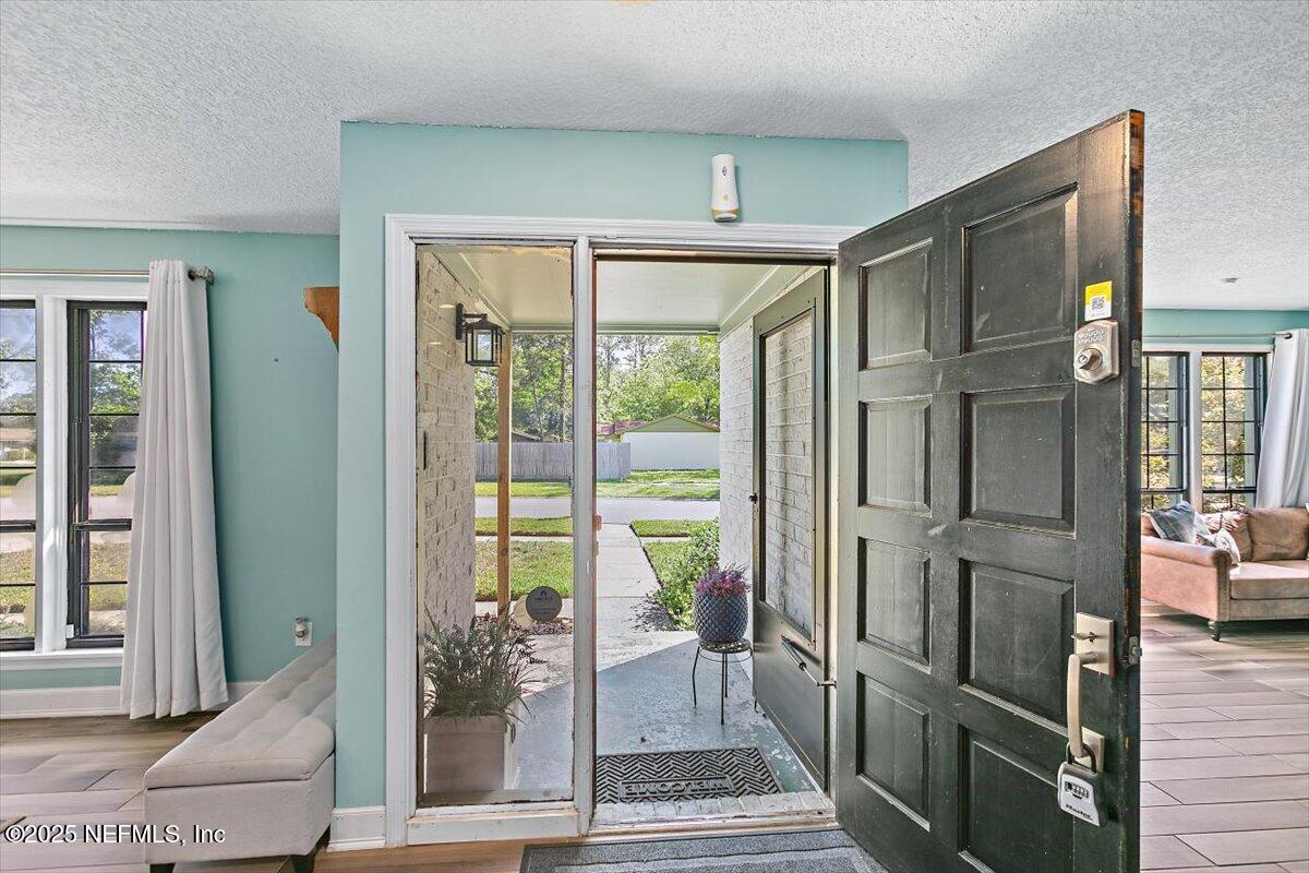 898 Perkins Place Jacksonville, FL 32221 - Photo 3 of 21 a view of a hallway with wooden floor and a living room