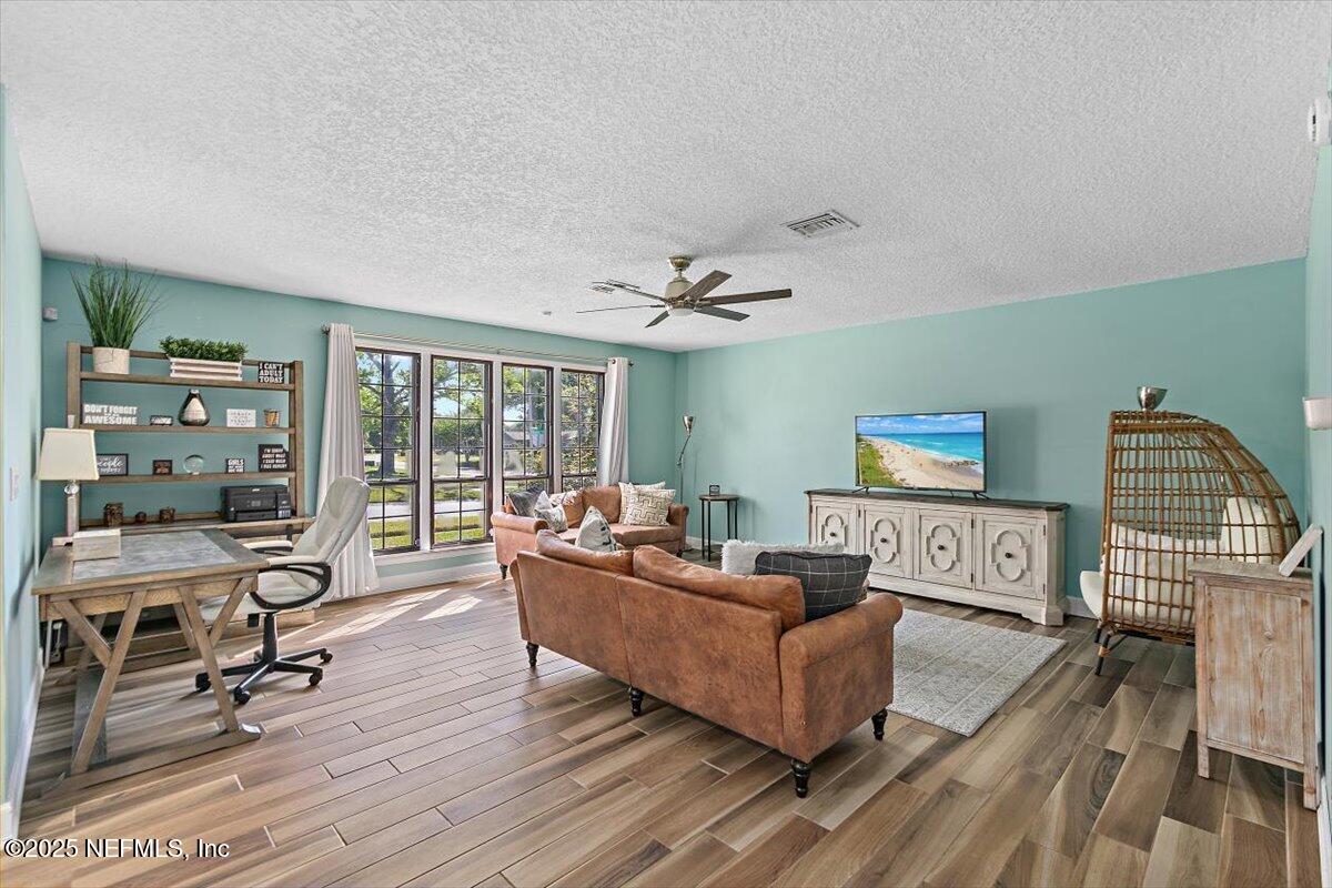 898 Perkins Place Jacksonville, FL 32221 - Photo 4 of 21 a living room with furniture and a wooden floor