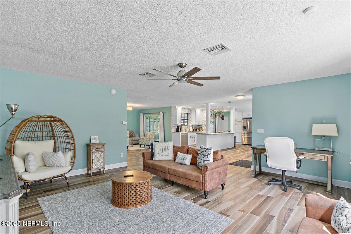 898 Perkins Place Jacksonville, FL 32221 - Photo 5 of 21 a living room with furniture a rug and a large window