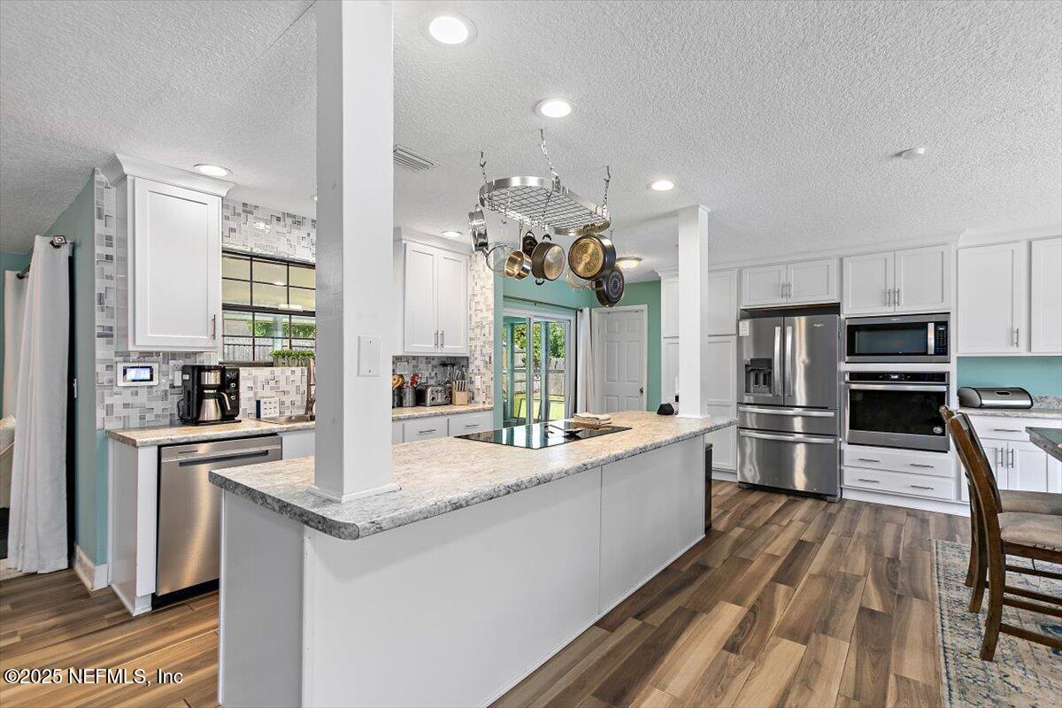 898 Perkins Place Jacksonville, FL 32221 - Photo 6 of 21 a large kitchen with granite countertop a large counter top appliances and cabinets