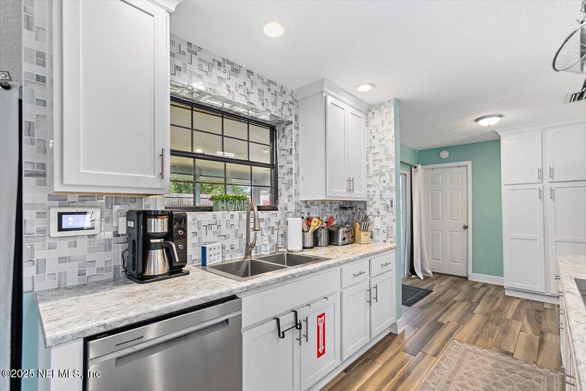 898 Perkins Place Jacksonville, FL 32221 - Photo 7 of 21 a kitchen with white cabinets and window