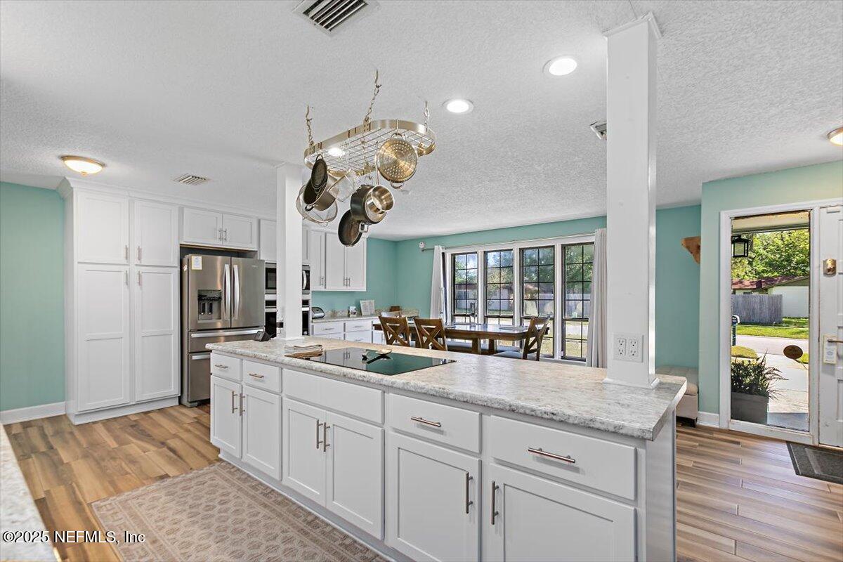 898 Perkins Place Jacksonville, FL 32221 - Photo 8 of 21 a kitchen with stainless steel appliances granite countertop a stove oven and a refrigerator with white cabinets