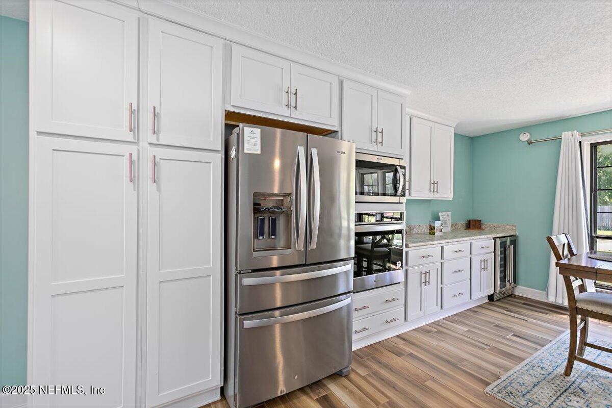 898 Perkins Place Jacksonville, FL 32221 - Photo 9 of 21 a kitchen with cabinets stainless steel appliances and a window