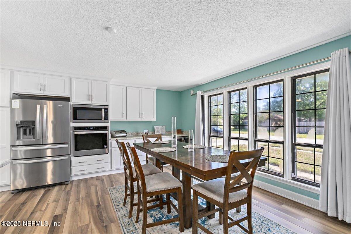 898 Perkins Place Jacksonville, FL 32221 - Photo 10 of 21 a view of a dining room with furniture window and wooden floor