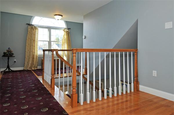 18 Wilkes Road Rowley, MA 01969 - Photo 15 of 29 a view of a hallway with wooden floor and staircase