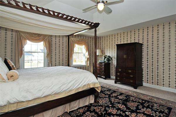 18 Wilkes Road Rowley, MA 01969 - Photo 16 of 29 a bedroom with a bed and a flat tv screen on dresser