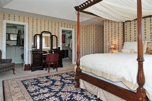 18 Wilkes Road Rowley, MA 01969 - Photo 17 of 29 a large bedroom with a bed and wooden floor