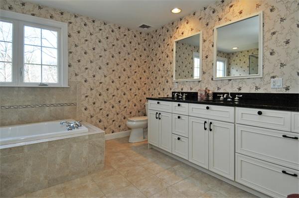 18 Wilkes Road Rowley, MA 01969 - Photo 20 of 29 a bathroom with a bathtub sink mirror and toilet