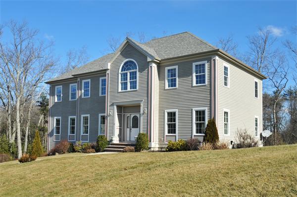 18 Wilkes Road Rowley, MA 01969 - Photo 2 of 29 a front view of a house with a yard