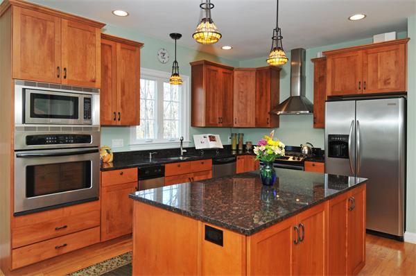 18 Wilkes Road Rowley, MA 01969 - Photo 4 of 29 a kitchen with granite countertop stainless steel appliances a stove sink microwave and cabinets