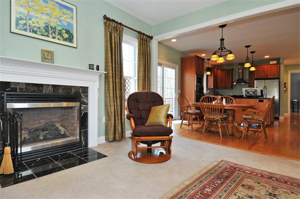 18 Wilkes Road Rowley, MA 01969 - Photo 8 of 29 a living room with furniture a dining table and a fireplace