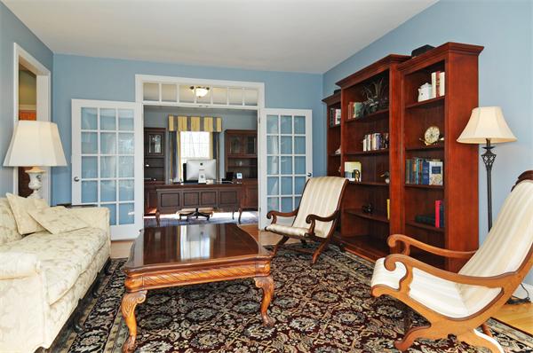 18 Wilkes Road Rowley, MA 01969 - Photo 10 of 29 a living room with furniture a rug and a chandelier