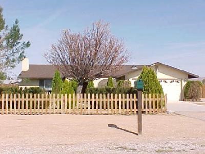 22308 Pahute Road Apple Valley, CA 92308 - Photo 1 of 1 a view of a house with a wooden fence