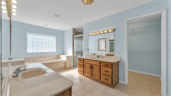 a bathroom with a granite countertop sink and a bathtub