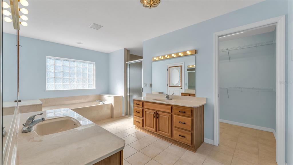 4647 Northeast 15th Street Ocala, FL 34470 - Photo 12 of 45 a bathroom with a granite countertop sink and a bathtub
